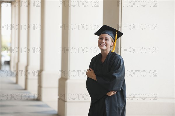 Smiling graduate woman in cap and gown
