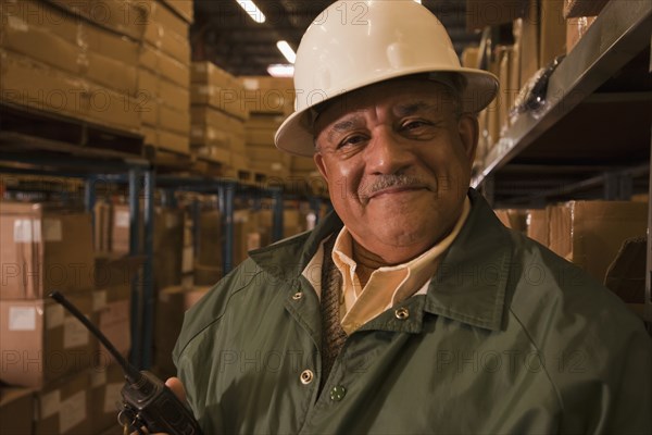 Mixed race man in hard-hat in warehouse