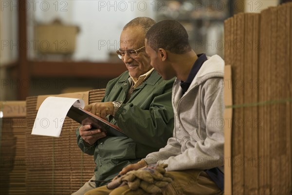 Manager talking with worker in warehouse