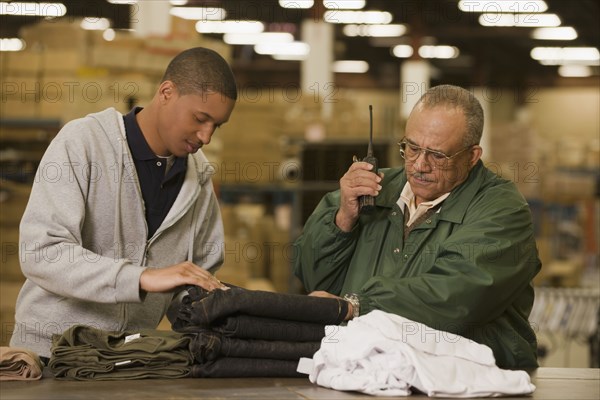 Manager talking with worker in warehouse