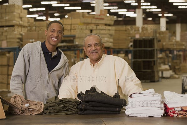 Manager standing with worker in warehouse