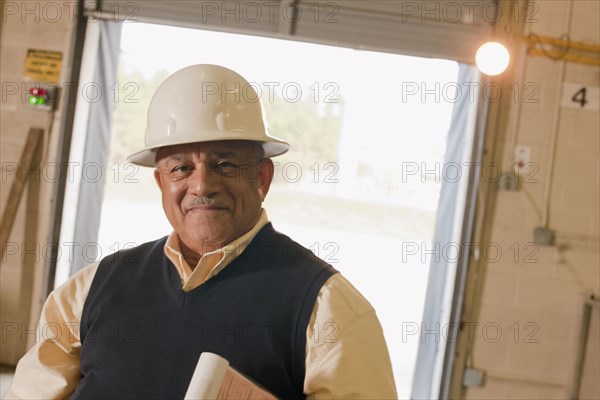 Mixed race man in hard-hat in warehouse