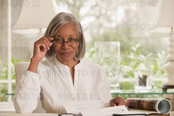 Black woman adjusting eyeglasses
