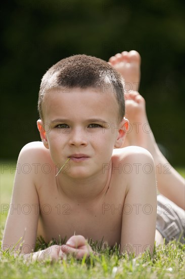 Caucasian boy laying in grass