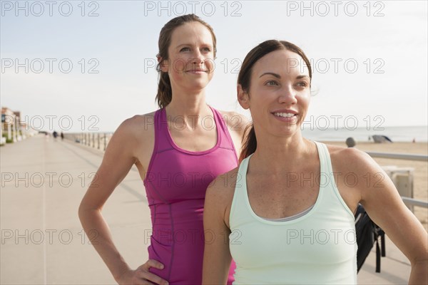 Caucasian women in sportswear at beach boardwalk