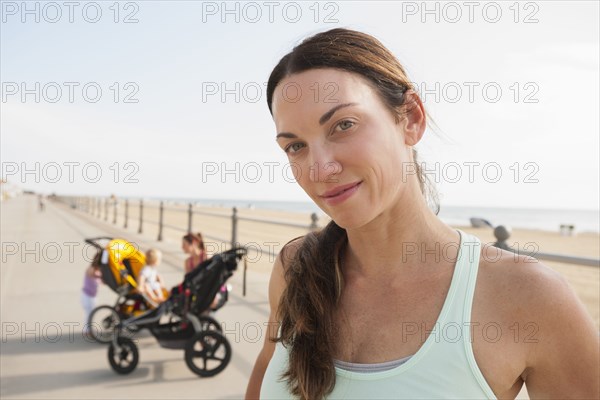 Caucasian woman smiling on beach boardwalk