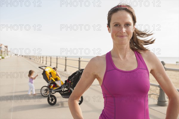 Caucasian woman smiling on beach boardwalk