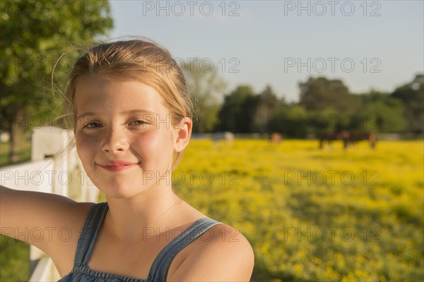 Caucasian girl smiling in rural landscape