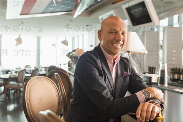 Caucasian businessman smiling in bar