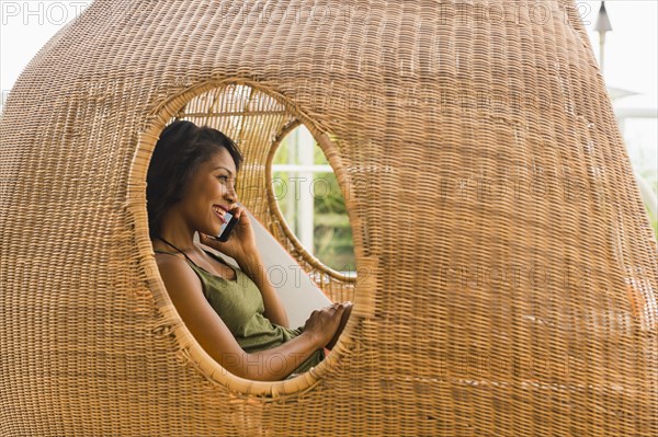 African American woman talking on cell phone in cabana