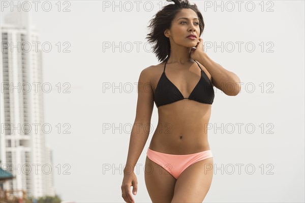 African American woman wearing bikini on beach