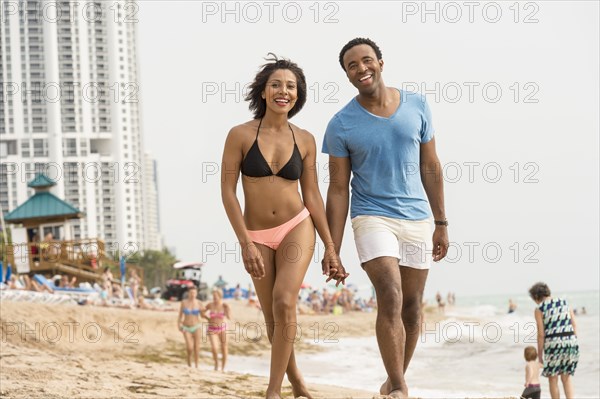 Couple holding hands on beach