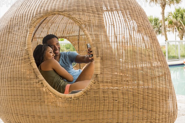 Couple taking selfie in cabana