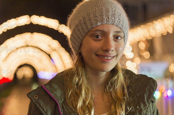 Portrait of smiling Caucasian girl on sidewalk