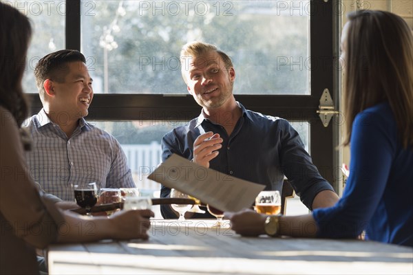 Friends talking at table in brew pub