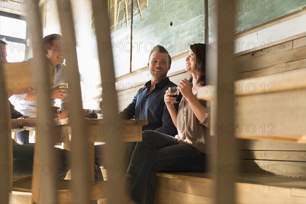 Friends talking in brew pub behind chair