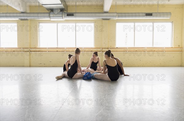 Girls sitting on floor of ballet studio