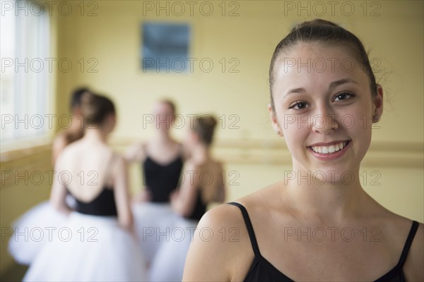 Portrait of girl smiling in ballet studio