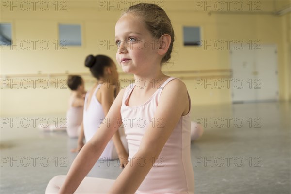 Girl sitting on floor of ballet studio