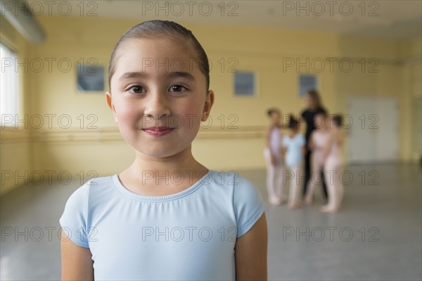 Portrait of smiling girl in ballet studio