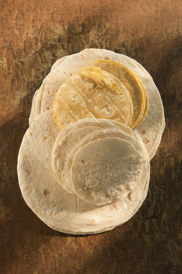 Flour and corn tortillas on table