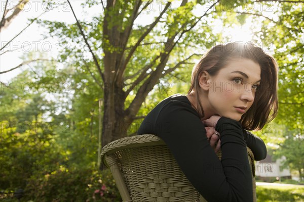 Caucasian woman sitting in chair outdoors