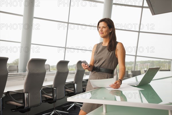 Caucasian businesswoman working in conference room