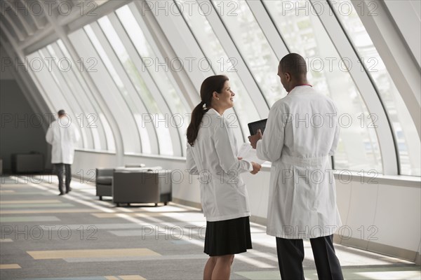 Doctors talking together in hospital corridor