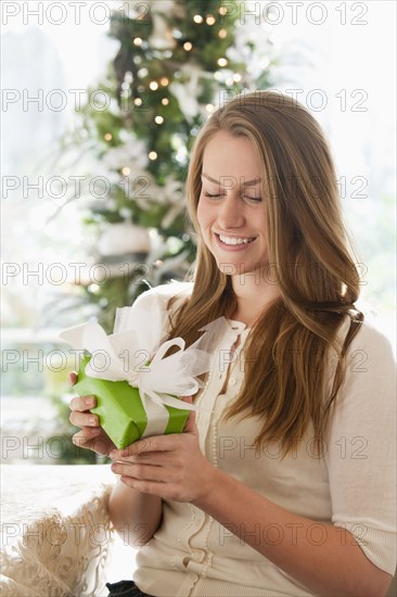 Caucasian woman holding Christmas gift