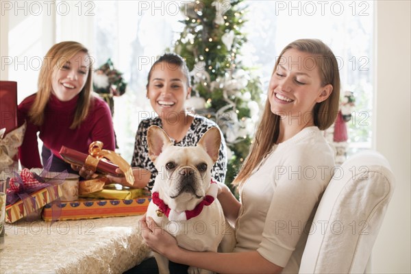 Friends and dog celebrating Christmas