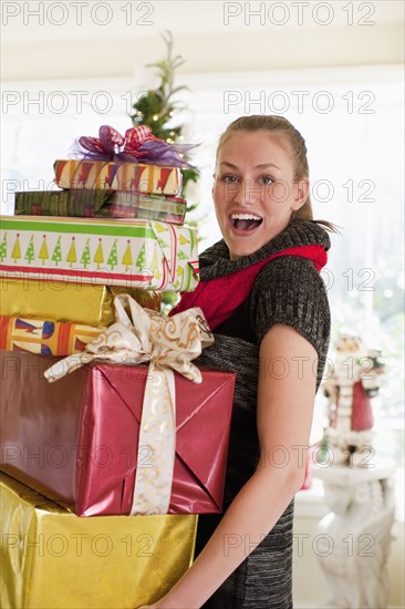 Caucasian woman carrying Christmas gifts