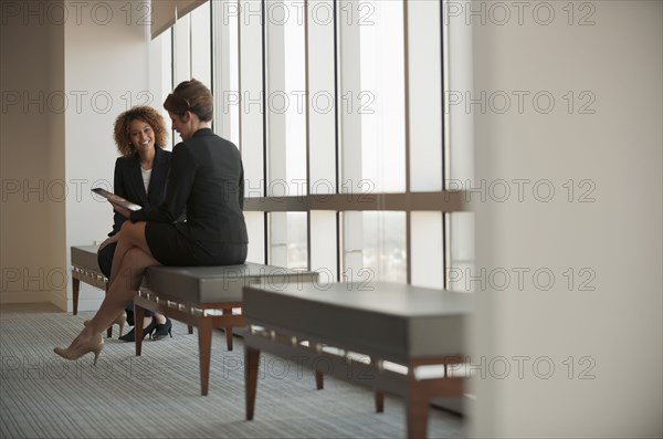 Businesswomen talking in waiting area