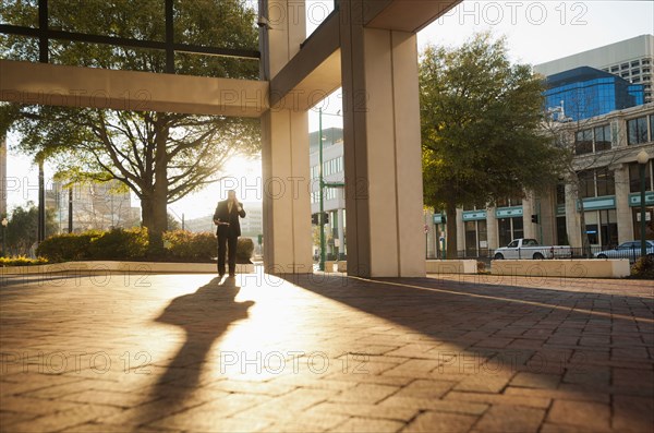 Caucasian businessman walking in urban area