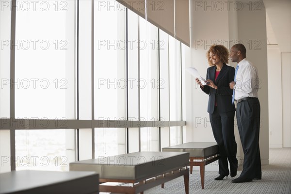 Business people talking together near window