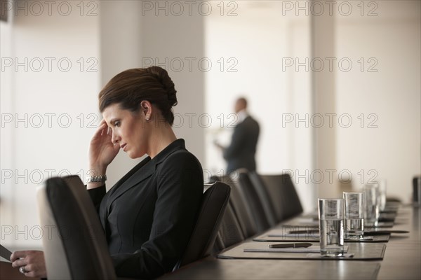 Caucasian business woman working in conference room