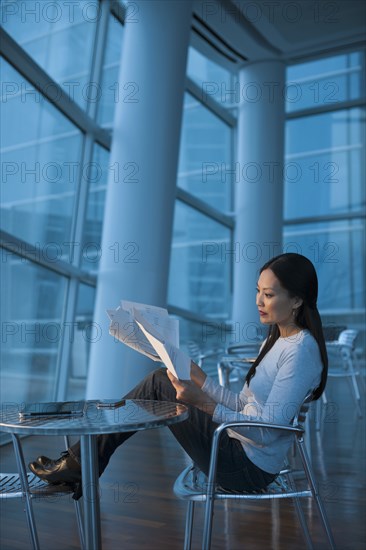 Asian businesswoman looking at paperwork