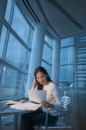 Asian businesswoman looking at paperwork