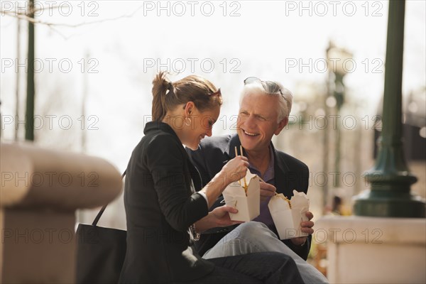 Caucasian business people eating Asian food