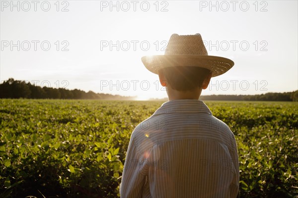 Caucasian boy overlooking rural field