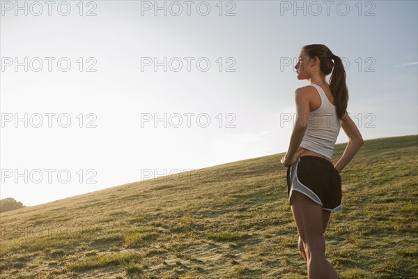 Caucasian runner standing in field