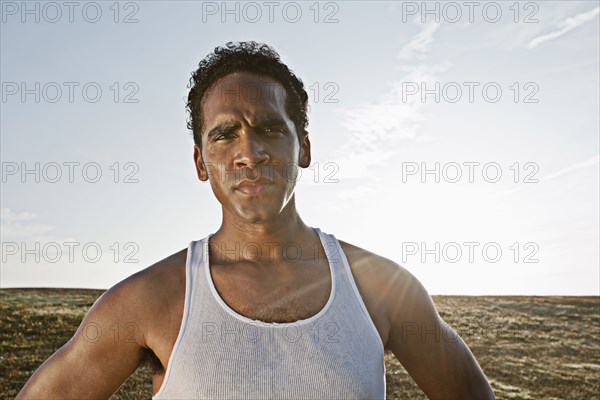 Serious Mixed race man standing outdoors