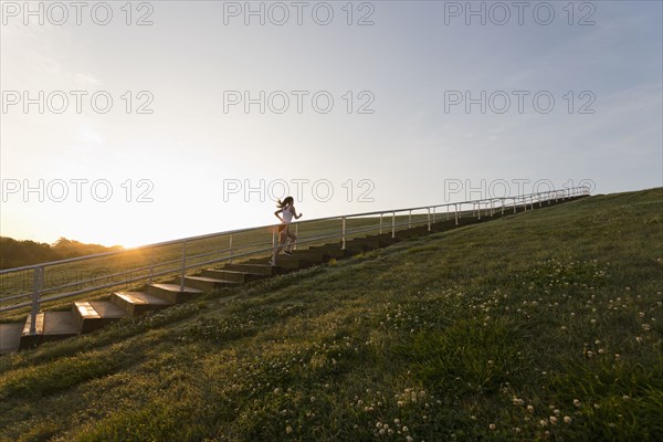 Caucasian woman running up steps