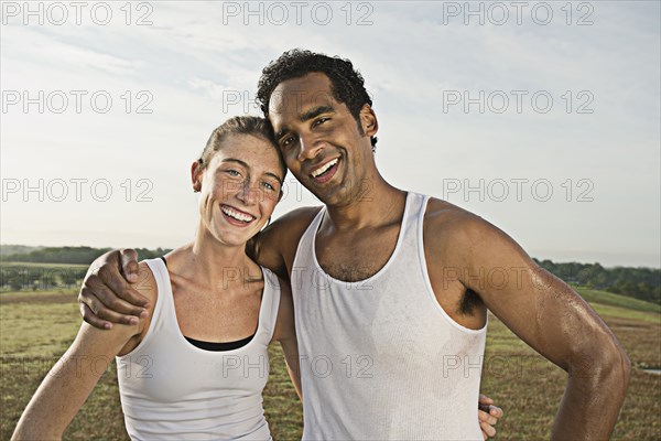 Couple hugging in field