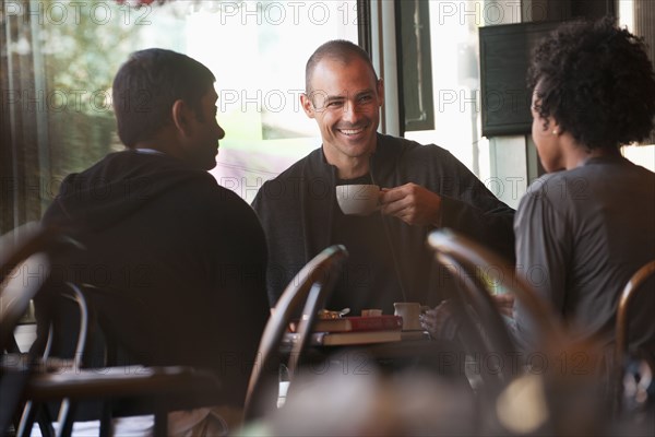 Friends sitting together in cafe