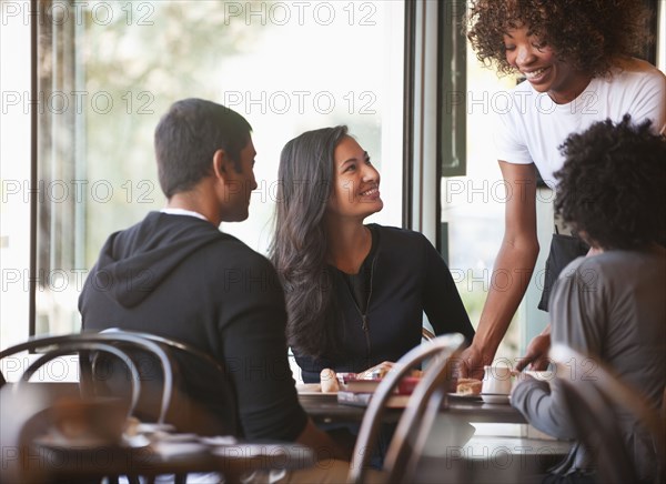 Friends sitting together in cafe