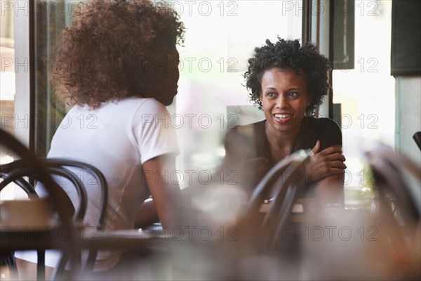 Black friends sitting together in cafe