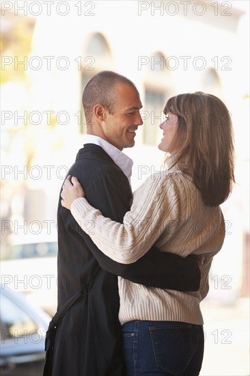 Caucasian couple hugging outdoors