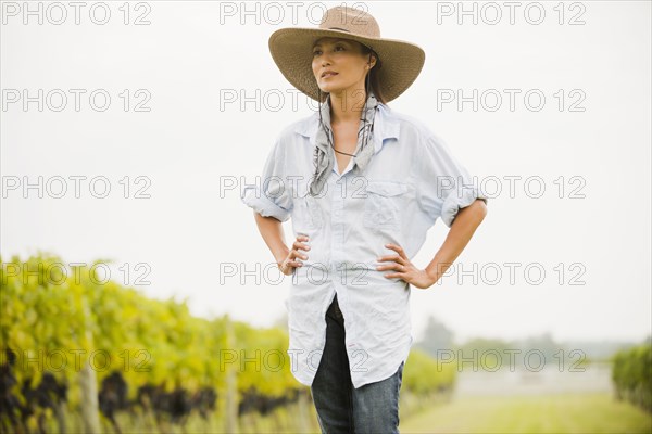 Asian woman walking in vineyard