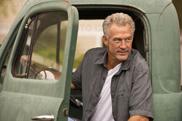 Caucasian farmer sitting in truck