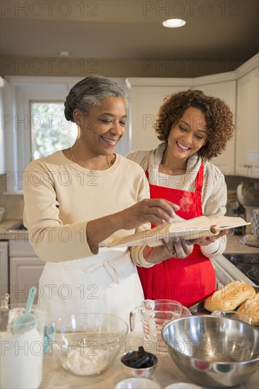 Mother and daughter baking in kitchen